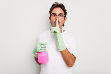 Young cleaner hispanic man isolated on white background keeping a secret or asking for silence.