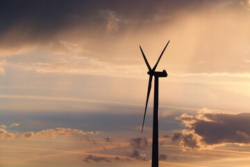 Obraz premium Windrad vor Abendhimmel mit Wolken