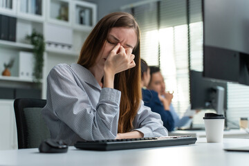 Cacasian young businesswoman worker having headache in office workplace