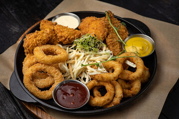 battered seafood in a pan on a black background
