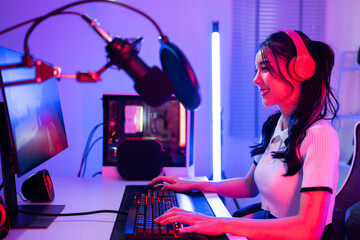 Asian beautiful Esport woman gamer play online video game on computer. © Kawee