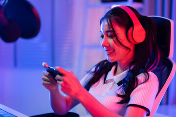 Asian beautiful Esport woman gamer play online mobile game on computer © Kawee