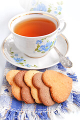 Cup of tea and homemade butter cookies in the shape of a heart