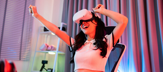 Asian young esport woman gamer use technology VR glasses and play game © Kawee