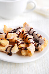 Sweet crunchy stick with chocolate coating on a white background