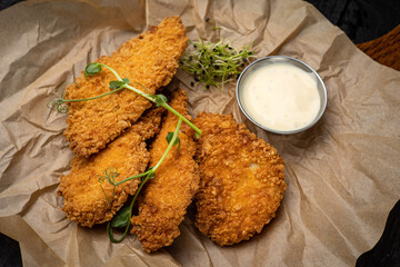 battered seafood in a pan on a black background
