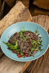 grilled meat with vegetables and spices on a black background

