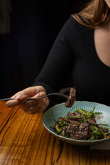 grilled meat with vegetables and spices on a black background
