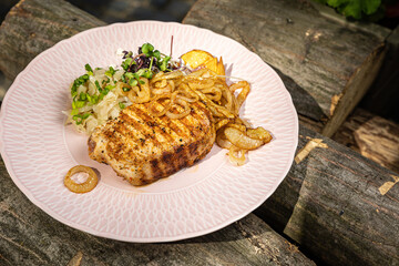 grilled meat with vegetables and spices on a black background
