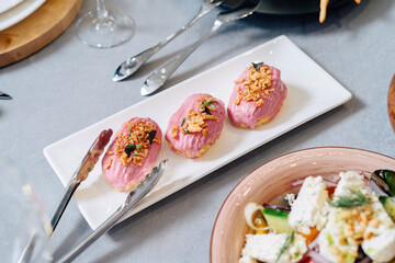 Eclair cakes. Eclair custard cakes with cream and raspberries covered with pink icing.