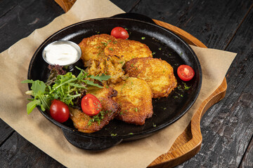 grilled meat with vegetables and spices on a black background
