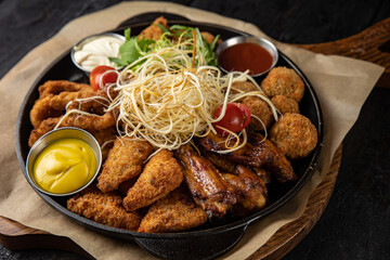 battered seafood in a pan on a black background
