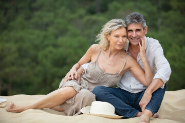 happy romantic middle aged couple on the sand