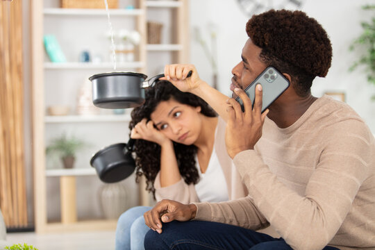 upset couple calling insurance for home leaks