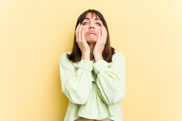 Young caucasian woman isolated on yellow background whining and crying disconsolately.