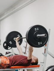 Young man trains his body to stay fit and have defined muscles.