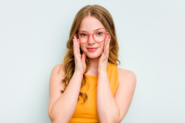 Fototapeta premium Portrait of pretty young caucasian wearing glasses woman isolated on blue background