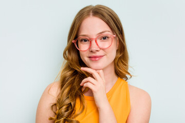 Portrait of pretty young caucasian wearing glasses woman isolated on blue background