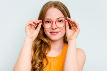 Portrait of pretty young caucasian wearing glasses woman isolated on blue background