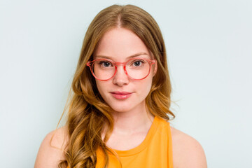 Portrait of pretty young caucasian wearing glasses woman isolated on blue background