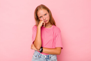 Caucasian teen girl isolated on pink background tired of a repetitive task.