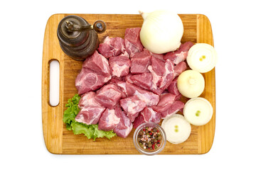 Raw fresh meat chunks, ingredients for goulash, isolated on white background. High resolution image.