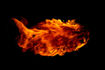 Flame of burning fire going through a black background