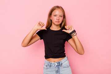 Caucasian teen girl isolated on pink background feels proud and self confident, example to follow.