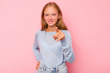 Caucasian teen girl isolated on pink background cheerful smiles pointing to front.