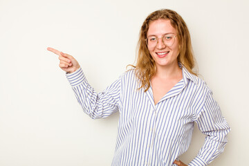 Young caucasian woman isolated on white background smiling cheerfully pointing with forefinger away.