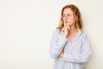 Young caucasian woman isolated on white background looking sideways with doubtful and skeptical expression.