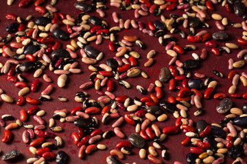 burgundy background with scattered organic beans