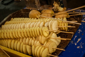 Malaysia, July 10, 2022 - Potato chips freshly fried for sale at night market.