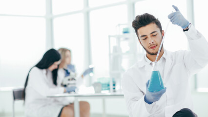 close up. the young scientist makes the analysis of the liquid