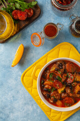 Pork stew with chorizo and black beans. Served with orange and seasoned with hot chili peppers....