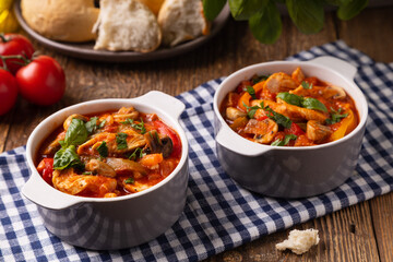 Chicken stew with peppers, mushrooms and tomatoes.