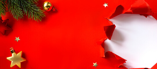 Christmas banner. Christmas tree branch decorated golden color balls and stars on red background. Wide Xmas banner mockup, header, flyer