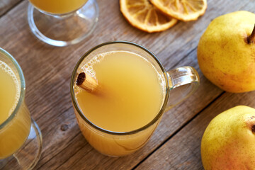 Homemade hot pear drink with cinnamon and fresh pears