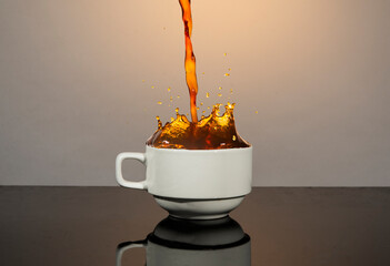 Coffee splash going out of white cup - hot drink concept