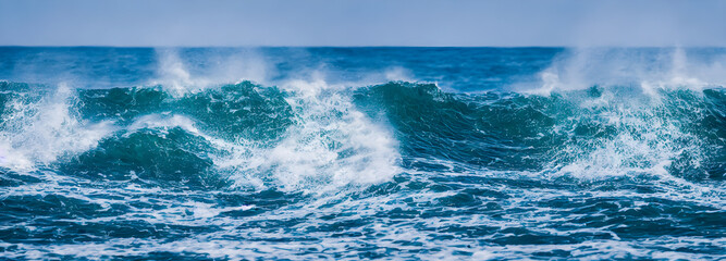 Fototapeta premium Ocean waves surface texture. Abstract blue water background with splashes of sea foam. 3d