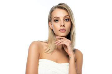 portrait of tattooed young woman with bare shoulders and blue eyes looking at camera isolated on white.