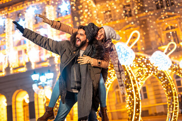 Boyfriend piggybacking girlfriend while celebrating New Year