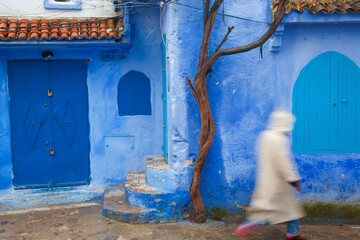 Man wearing a djellaba on the street, Chefchaouen, Morocco