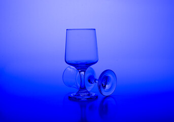 Glass of water on abstract blue background