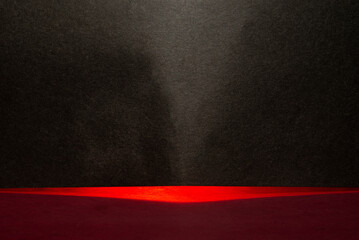 Red abstract light passing through black card making background