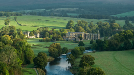 Early morning sunshine illuminates Bolton Abbey in Wharfedale, North Yorkshire, England, takes its name from the ruins of the 12th-century Augustinian monastery now known as Bolton Priory