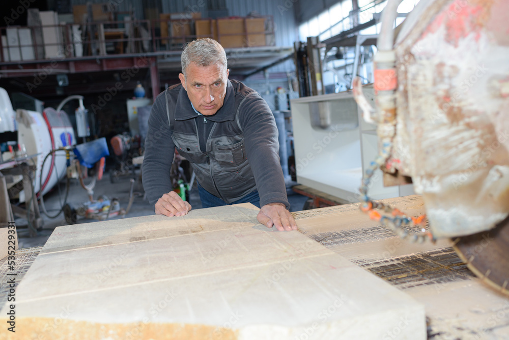 Wall mural man makes measurements of the board