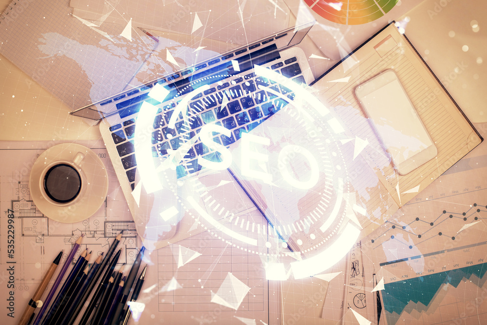 Poster Double exposure of SEO drawing over study table background with computer. Concept of search. Top view.