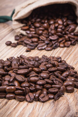 Dark roasted fragrant coffee beans in jute bag
