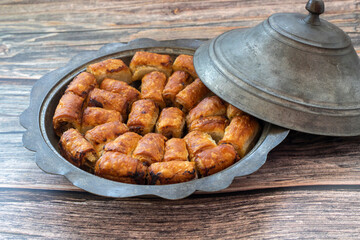 Traditional Bosnian pastry with minced meat (minced meat) in a metal plate. Turkish name; Bosnian dumplings.